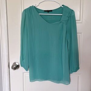 Teal blouse with shear 3/4 sleeves. Size small. 55% silk, 45% viscose